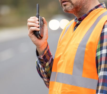 Road construction workers talking to walkie-talkie